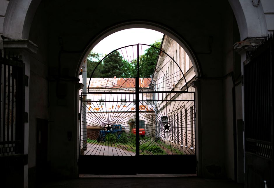 A swing gate with picket infill and a sturdy frame.