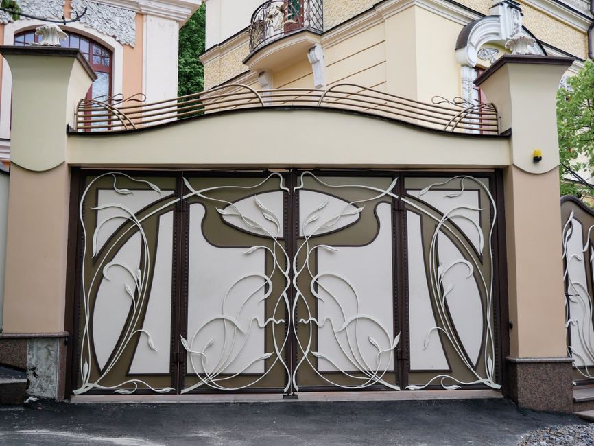 A swing gate with picket infill and a sturdy frame.