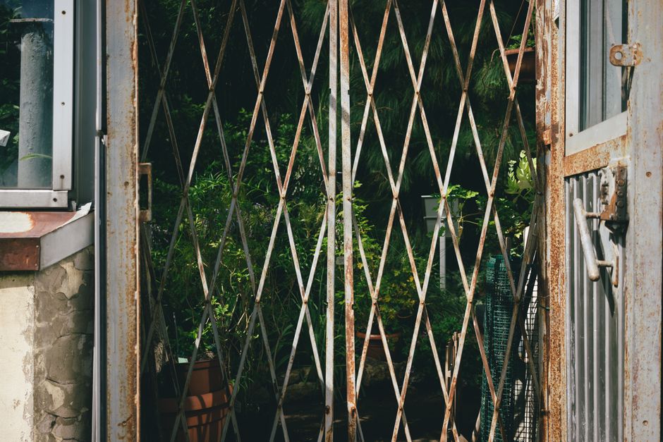 A metal gate with a powder coat finish and a latch on the post.